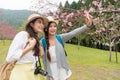 Asian woman taking selfie together Royalty Free Stock Photo