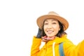Asian Woman taking selfie in yellow coat