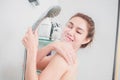 Asian Woman taking a shower enjoying water splashing on her