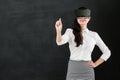 Asian woman teacher writing chalk with VR headset