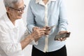 Asian woman teaching the old people how to use mobile phone,Happy smiling senior grandma learning to use smartphone,scanning the