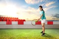 Asian woman with a tennis racket and ball in her hands ready in serve position Royalty Free Stock Photo