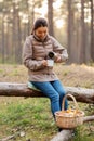 asian woman with thermos drinking tea in forest