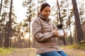 asian woman with thermos drinking tea in forest