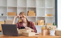 Asian woman think hard serious working laptop computer at home selling online start up small business owner, e-commerce Royalty Free Stock Photo