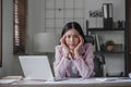 asian woman thinking hard concerned about online problem solution looking at laptop screen, worried serious asian Royalty Free Stock Photo