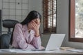 asian woman thinking hard concerned about online problem solution looking at laptop screen, worried serious asian Royalty Free Stock Photo