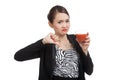 Asian woman thumbs down hate tomato juice Royalty Free Stock Photo