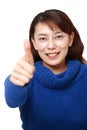 Asian woman with thumbs up gesture