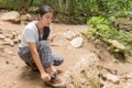 Asian woman tie her shoe in the forest Royalty Free Stock Photo