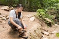 Asian woman tie her shoe in the forest Royalty Free Stock Photo