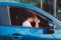 Asian woman tired driving long in the blue car her parking safety and protect risk