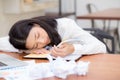 Asian woman with tired overworked and sleep, girl have resting while work writing note Royalty Free Stock Photo