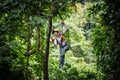 Asian woman TOURIST adult wearing casual clothes Zip Line On Focus FOREST TR Royalty Free Stock Photo