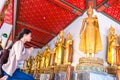 Asian women tourist backpack is worshiping the image of Buddha in holiday at wat pho Bangkok Thailand. It is a landmark and Royalty Free Stock Photo