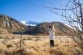 Asian woman tourist capturing beautiful snow mountain in rural at New Zealand