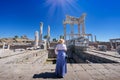 Asian woman tourist Standing and asking for blessing from god according to belief in Altar of Zeus, Temple of Trajan Acropolis of