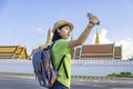 Asian Woman tourist Travel backpack Watch the Emerald Buddha Temple or Wat Phra Kaew. He is standing selfie photograph By