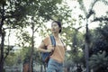 Asian woman tourist traveller backpack watching the beauty of the public park On vacation and relax happily. at Bangkok Thailand Royalty Free Stock Photo