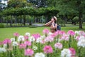 Asian women tourists backpack he is standing enjoying the fresh air. at spider flower garden. happily during travel the holidays Royalty Free Stock Photo