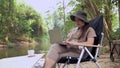 Asian woman travel and camping alone. Businesswoman online working and relaxing during journey outdoor