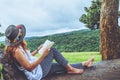 Asian woman travel nature. Travel relax. Study read a book. Nature Education. At public park in summer