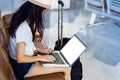 Asian Woman travel typing computer at airport Royalty Free Stock Photo