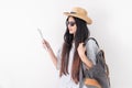 Asian woman traveler backpacker use map and mobile phone app to search for route location of place with gps on white background,