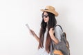Asian woman traveler backpacker wear sunglasses use map to search for route location of place with gps on white