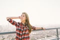 Asian woman traveler or college student smile and enjoy view on building roof, evening sunset. Relax leisure activity concept Royalty Free Stock Photo