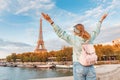 Asian woman traveler posing at the background of majestic Eiffel tower. Tourism and lifestyle in France and Paris. Vacation