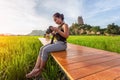 Asian woman traveler take a photo and enjoying at Wat Tham Suea background, Kanchanaburi Province, Thailand