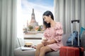 Asian woman traveller open curtain of hotel room for see view for chao phraya river and wat arun temple