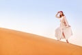 Asian woman in turban travels in Sahara desert. Adventure and life experience concept Royalty Free Stock Photo