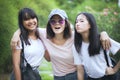 Asian woman and two teenager happy with relaxing in green park