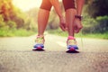 Asian woman tying shoelace on fossil forest trail Royalty Free Stock Photo