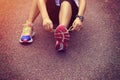 Asian woman tying shoelace on fossil forest trail Royalty Free Stock Photo