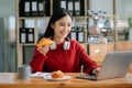 Asian woman typing smartphone, keyboard with laptop computer of Social media and Marketing virtual icons screen concept Royalty Free Stock Photo