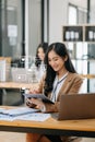 Asian woman typing smartphone, keyboard with laptop computer of. Social media and Marketing virtual icons screen concept Royalty Free Stock Photo