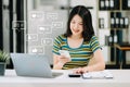 Asian woman typing smartphone, keyboard with laptop computer of Social media and Marketing virtual icons screen concept Royalty Free Stock Photo