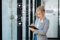 Asian woman typing smartphone, keyboard with laptop computer of Social media and Marketing virtual icons screen concept Royalty Free Stock Photo