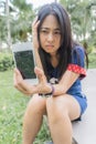 Asian woman unhappily at broken smart phone. Royalty Free Stock Photo