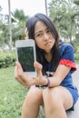 Asian woman unhappily at broken smart phone. Royalty Free Stock Photo