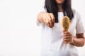 Woman weak hair her hold hairbrush with damaged long loss hair in the comb brush she pulls loss hair from brush Royalty Free Stock Photo