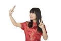 Asian woman using a cell phone to take a selfie isolated on whit Royalty Free Stock Photo