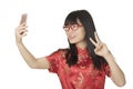 Asian woman using a cell phone to take a selfie isolated on whit Royalty Free Stock Photo