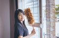 Asian woman using a dust brush,Hands of housemaid,dusting