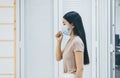 Asian woman using face mask protect PM 2.5 because pollution in office