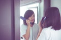 Asian woman using hair irons with straightening Royalty Free Stock Photo