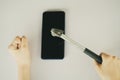 Asian woman using hammer to break her smartphone Royalty Free Stock Photo
